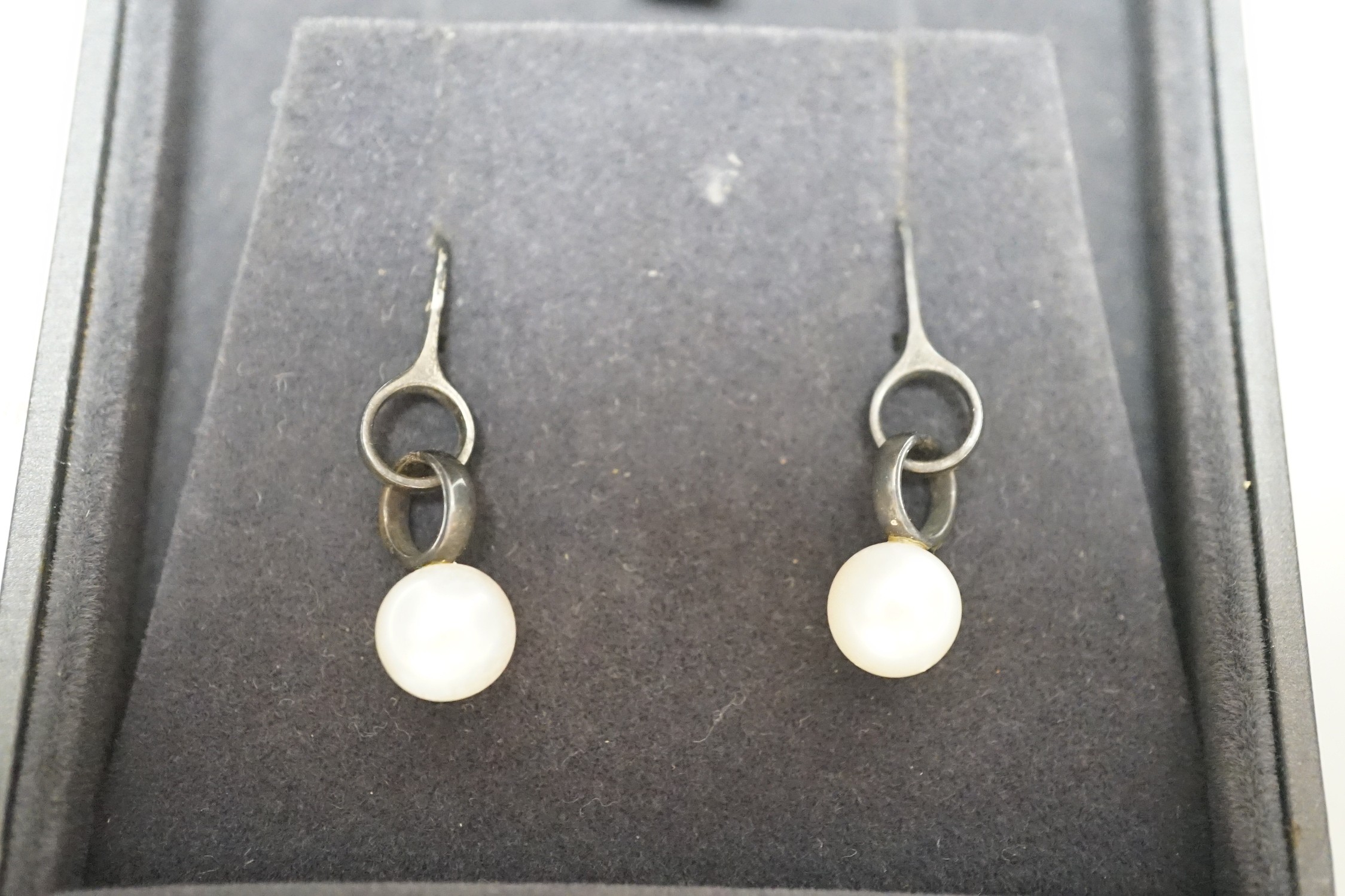 A modern pair of Georg Jensen silver and cultured pearl set drop earrings, 31mm, in Georg Jensen box.